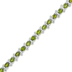 Bursting with color, this gemstone bracelet is a look she'll turn to often. Created in sterling silver, this intriguing style showcases 4 x 3.0mm oval-shaped forest-green chrome diopside alternating with "S" - shaped links. Polished to a bright shine, this 7.75-inch bracelet secures with a lobster claw clasp. Green Oval Sterling Silver Bracelet, Green Oval Sterling Silver Bracelets, Oval Green Sterling Silver Bracelet, Green Oval Tennis Bracelet As Gift, Green Oval Tennis Bracelet For Gift, Green Chrome, Oval Stone, Green Stone, Tennis Bracelet