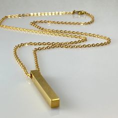 Mirror polished rectangular square bar on a cable chain stainless steel chain. The length can be made to any required. Materials: Gold plated stainless steel Measurements: cable chain can be made to length required, rectangular bar 5 mm wide, 40 mm long, hole 2.9 mm Weight: 12 gm Why you should love stainless steel: * Waterproof * Hypoallergenic * Non-reactive to sweat, salt & chlorinated water * Rust, corrosion & scratch resistant - it still can be dented, though! * It's a planet friendly produ Rectangular Stainless Steel Necklaces, Modern Jewelry With Rectangular Cable Chain, Modern Gold Bar Necklace With Rectangular Pendant, Gold Minimalist Rectangular Bar Necklace, Minimalist Gold Rectangular Bar Necklace, Gold Rectangular Minimalist Bar Necklace, Long Drop Necklace, Pastel Necklace, Square Bar