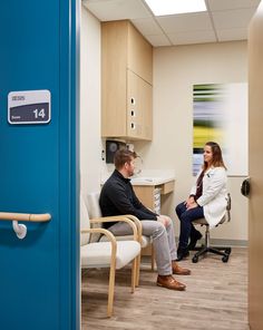 a man and woman are sitting in an office waiting for their doctor's appointment