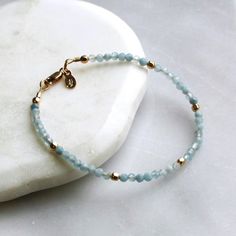 Gorgeous natural aquamarine is hand strung to create this beaded bracelet.  It's accented with 14kt gold filled touches.  Aquamarine is know as the happiness stone! D E T A I L S *Hand strung genuine natural aquamarine, 3mm *14kt gold filled accent beads  *Available in a 6.5 or 7.0 inch length with an optional extender ∙ EXTRA LOVE ∙ Handcrafted just for you in sunny Arizona by a team of talented women. All of our jewelry comes gift packaged! We are happy to leave a note if this is a special gif Aquamarine Beaded Bracelet As Gift, Aquamarine Beaded Bracelets As Gift, Beaded Aquamarine Bracelet For Gift, Adjustable Beaded Aquamarine Bracelets, Adjustable Aquamarine Beaded Bracelets, Beaded Aquamarine Bracelets, Adjustable Aquamarine Beaded Bracelet As Gift, Adjustable Aquamarine Beaded Bracelets As Gifts, Elegant Aquamarine Beaded Bracelets