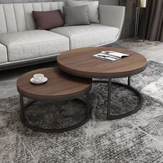 two tables sitting on top of a rug in front of a couch