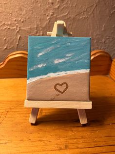 a small easel with a heart painted on it