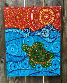 a painting on the side of a wooden fence with a turtle swimming in the ocean