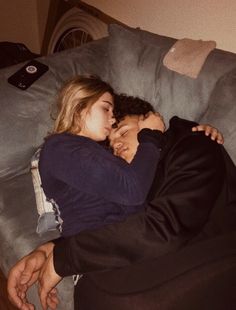 a man and woman cuddle together on a bean bag chair