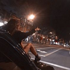 a person sitting in the passenger seat of a car at night