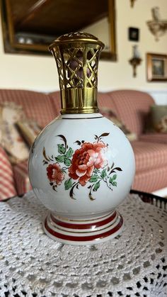 a white vase sitting on top of a table