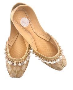 Ethnic Flair: Handcrafted Indian/pakistani/asian wedding/party shoes adorned with intricate pearl embellishments and mirror work. Versatile Style: Suitable for bridal wear, parties, Eid, Diwali,birthday and other festive occasions. Comfortable Fit: Khussa/jutti-style flats with soft insoles for all-day comfort. Timeless Elegance: gold-colored jamawar fabric with delicate pearl and mirror accents. Handmade Craftsmanship: Each pair is meticulously handmade by skilled artisans. Traditional Wear With Pearl Embroidery For Reception, Traditional Pearl Embroidery Wear For Reception, Gold Traditional Wear With Pearl Embroidery For Reception, Traditional Wear With Pearl Embroidery For Party, Traditional Festive Wear With Pearl Embroidery, Festive Traditional Wear With Pearl Embroidery, Traditional Party Wear With Pearl Embroidery, Traditional Pearl Embroidered Party Wear, Bollywood Traditional Wear With Pearl Embroidery For Festivals