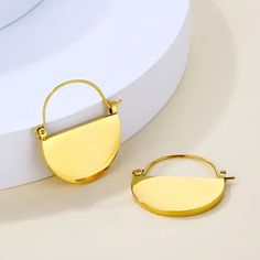 The perfect statement earrings for any occasion, these minimalist 18K gold plated stainless steel hoops are lightweight, tarnish free, hypoallergenic, and great for sensitive skin. You can return them if you don't like them without any hassle.   100% eco-friendly recycled statement earrings. First class delivery 1-2 days within the UK.  ⭐ Length: 28 mm (2.8 cm) ⭐ Diameter: 25 mm (2.5cm) ⭐ Closure: Click-down clasp For other styles, visit:  https://www.etsy.com/uk/shop/SatisjewelleryStore * * --- ✤ R E F U N D S &  R E T U R N S ✤---  **   ACCEPTED. Full refunds and returns accepted if you are not happy with your purchase. Due to hygiene reasons, items must not be worn.  * * --- ✤ P A C K A G I N G ✤---  **   Comes in a stylish white suede jewellery pouch. It's a great gift or treat for you Stainless Steel Yellow Gold Hoop Earrings Gift, Minimalist Gold-tone Hoop Huggie Earrings, Minimalist Stainless Steel Tarnish Resistant Huggie Earrings, Trendy Gold Plated Tarnish Resistant Hoop Earrings, Chic 14k Gold Filled Hoop Earrings Gift, Minimalist Metal Hoop Earrings Tarnish Resistant, Minimalist Stainless Steel Hoop Earrings For Everyday, Minimalist Nickel-free Stainless Steel Hoop Earrings, Trendy Tarnish Resistant 14k Gold Filled Hoop Earrings