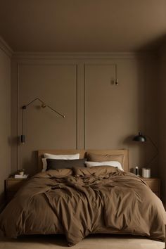 a large bed sitting in a bedroom next to a wall with two lamps on it