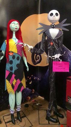 two halloween costumes are on display in front of a wall with pumpkins and jack skelling