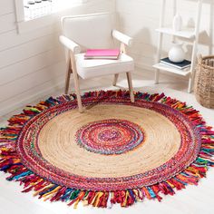 a white chair sitting on top of a rug