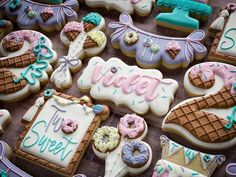 decorated cookies and pastries are displayed on a table with the words sweet written in frosting