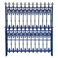 a blue iron fence with ornate designs on the top and bottom, against a white background