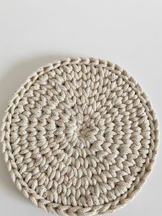 a crocheted placemat on a white surface