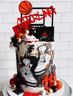 a birthday cake decorated with basketballs and sneakers