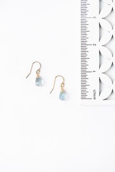 A beautiful gift for those born in March, featuring their birthstone of a stunning hand wrapped aquamarine briolette. These feminine earrings dangle at 1" from gold filled ear wires. Gold Filled (lead and nickel free) Aquamarine 1", on gold filled ear wires We hand select our natural materials, thus there may be slight variations in color and/or size that will not detract from the overall aesthetic Our unique handcrafted designer jewelry for women is made in America, with each design created ind Gold Aquamarine Teardrop Jewelry, 14k Gold Filled Teardrop Earrings For Gift, Gift Crystal Briolette Earrings With Ear Wire, Teardrop Blue Topaz Birthstone Earrings, Briolette Crystal Earrings With Ear Wire For Gift, Blue Topaz Teardrop Birthstone Earrings, Briolette Crystal Earrings For Gifts, Gift Teardrop Crystal Earrings With French Hook, Teardrop Jewelry With French Hook For Gifts