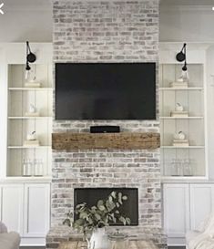 a living room filled with furniture and a flat screen tv mounted on the wall above a fireplace