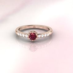 "The ruby Rarissime ring by ASCHERON. The word \" Rarissime \" means extremely rare. The Rarissime ring evokes the feeling of finding your soulmate. Ruby and diamond engagement ring by ASCHERON. Vintage inspired diamond ring with a hexagonal setting and fine millgrain detail. Tiny heart patterns are cut into the side of the setting. ASCHERON is bespoke jewelry design brand. Our pieces are excellent quality and are highly collectible. Gemstone - real ruby gemstone measuring 4mm round. Diamonds - Diamond Ruby Ring With Center Stone For Promise, Fine Jewelry Ruby Ring With Brilliant Cut For Promise, Promise Ruby Diamond Ring With Prong Setting, Ruby Ring With Center Stone For Promise, Promise Ruby Ring With Center Stone, Ruby Solitaire Ring For Promise, Solitaire Ruby Ring For Promise, Promise Ruby Solitaire Ring With Diamond, Promise Ruby Ring With Round Cut Center Stone