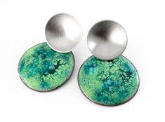 Crackle enamel earrings. Green enamel earrings. Statement green earrings. Circle post earrings. Abstract earrings. Modernist earrings Silver and crackle green enamel earrings. Measurements: 39mm length and 25mm width. Closure: push back. These circle post earrings are a one of a kind piece of contemporary jewelry. These statement green earrings are light and comfortable. Ideal to wear at a special event or wear them daily providing personality and a note of color. These modernist earrings are a Green Enamel Jewelry With Black Enamel, Modern Green Metal Earrings, Modern Green Round Earrings, Modern Nickel-free Green Earrings, Modern Green Nickel-free Earrings, Modern Green Enamel Jewelry, Unique Green Metal Earrings, Hand Painted Green Modern Jewelry, Modern Hand Painted Green Jewelry