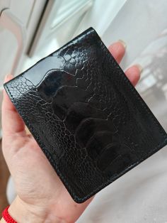 Handmade genuine ostrich leather wallet. Exterior made of 100% genuine ostrich leather and genuine leather and fabric inside.  - 1 main compartment - 8 card slots Material: Genuine ostrich leather Construction: handmade Color options: black color Dimensions: 4.34' x 3.46' x 0.5' (8.8cm x 11 cm x 1.2 cm)  Please feel free to contact me with any questions.  Ostrich is a luxurious leather well know for its softness, flexibility and durability.  In spite of its softness, Ostrich leather is unsurpassed for its tactile strength.  It is, in fact one of the strongest leathers available.  Naturally occurring oils in the leather contribute to its durability, preventing cracking, even under extreme temperatures and sun exposure. Happy shopping! Please, contact me with any questions! Luxury Men's Crocodile Pattern Wallet, Luxury Black Smooth Grain Trifold Wallet, Hand-stitched Black Leather Wallet, Black Textured Leather Rectangular Wallet, Luxury Black Crocodile Pattern Wallet, Luxury Wallet, Ostrich Leather, Handmade Leather Wallet, Handmade Purses