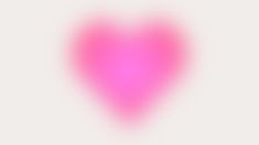 a blurry pink heart on a white background