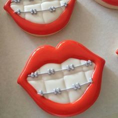 decorated cookies in the shape of mouths and teeth