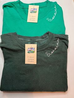 *Photo Listing is Crunchberry with Cream Thread Farmhouse Font* Rep your favorite player, team, group, organization, whatever it might be you will love these custom embroidered long sleeve Comfort Colors t-shirts. Embroidered along the neckline, you can put whatever you would like for this to say, leave this information in the personalization box below.   Please keep word length to a minimum, the neckline is only so big and for it to turn out great keep that in mind when deciding.  If you want a Casual Green Tops With Embroidered Logo, Casual Green T-shirt With Embroidered Logo, Relaxed Fit Green Top With Embroidered Logo, Green Relaxed Fit Top With Embroidered Logo, Relaxed Fit Crew T-shirt With Custom Embroidery, Custom Embroidered Relaxed Fit Crew T-shirt, Green Embroidered Text Short Sleeve T-shirt, Green Crew Neck T-shirt With Custom Embroidery, Green Embroidered Crew Top