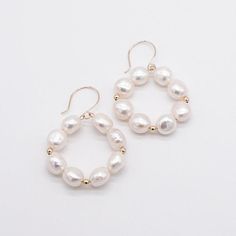 These Freshwater Pearl Circular Bridal Earrings are a wonderful way to wear freshwater pearls! Check out the newest trend in pearl jewellery with our pearl circle earrings.  Featuring a great look and plenty of trending style, these chunky hoop pearl earrings are a great way to wear pearls on your wedding day! Great as a bridesmaid gift, these pearl round earrings are the latest in fashion trends!  Fashionable and trendy, these pearl circle earrings are a wonderful addition to your bridesmaids' White Round Earrings For Bridesmaids, White Round Bridal Earrings For Bridesmaid, White Round Earrings For Bridesmaid Gift, White Bridal Earrings For Bridesmaid Gift, White Round Bridal Earrings For Bridesmaid Gift, Pearl Drop Jewelry For Bridesmaid Gift, Hypoallergenic White Hoop Earrings For Wedding, Pearl Earrings For Bridesmaid Gift, Round Pearl Drop Earrings For Bridesmaid Gift