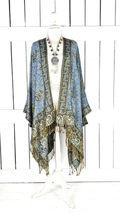 Handmade steel blue and gold paisley pashmina kimono cover up jacket with custom regular and maxi lengths and optional fringe detail Measurements...taken flat - width across seam to seam: 46"  - regular length with fringe: 38"  - regular length without fringe: 34"  - Maxi length is as selected with or without fringe Features... - lovely soft woven medium weigh pashmina fabric - bohemian oversized flowing design - cardigan style with an open front and generous arm holes  - universal design allows a comfortable fit for small through plus sizes - the perfect layering piece that can easily be dressed up or down - wrinkle resistant  - handmade with love by me in California Add a matching attached hood with this link... https://www.etsy.com/listing/1283867624/add-a-matching-hood?click_key=cb563d Bohemian Blue Cape-style Outerwear, Bohemian Blue Cape Outerwear, Bohemian Festival Outerwear With Beaded Fringe, Blue Bohemian Shawl Wrap, Bohemian Kimono With Fringe Shawl, Bohemian Shawl Kimono With Fringe, Bohemian Shawl Cape With Tassels, Blue Bohemian Cape Shawl, Bohemian Shawl With Tassels In Cape Style