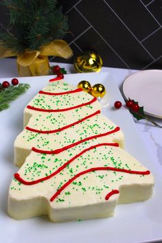 a christmas tree shaped cake sitting on top of a white plate