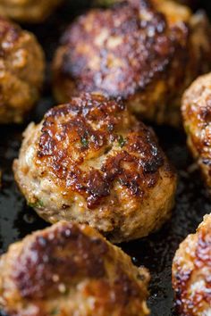 some meatballs are cooking in a frying pan