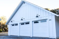 two white garages with three lights on each side