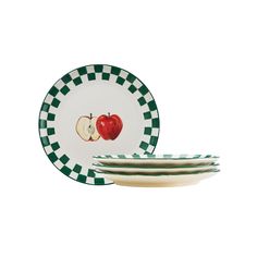 four green and white plates with an apple on one plate, two are stacked in front of each other