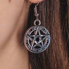 Unleash your inner gothic style with these stunning Pentagram Earrings! Made from high-quality alloy steel, measuring 2 inches in length, they feature a captivating black stone at the center of the pentagram. Add a touch of dark elegance to your wardrobe now! Black Alloy Halloween Jewelry, Black Alloy Jewelry For Halloween, Silver Star-shaped Alloy Jewelry, Black Gothic Stainless Steel Earrings, Halloween Metal Jewelry With Oxidized Finish, Halloween Oxidized Metal Jewelry, Black Star Shaped Metal Jewelry, Black Star-shaped Metal Jewelry, Gothic Silver Metal Plug Earrings