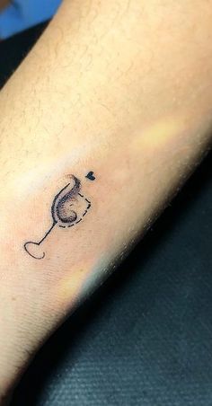 a person with a small tattoo on their left arm that has a mouse in it