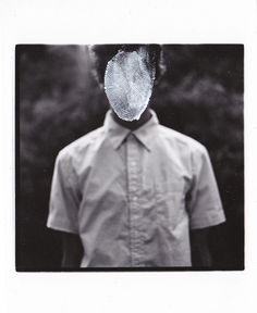 a black and white photo of a person wearing a shirt with a mesh covering his face