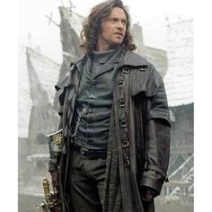 a man with long hair wearing a leather coat