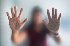 a blurry image of a person with their hands up in front of the camera