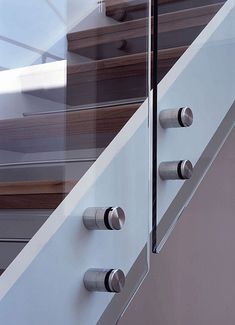 an image of a stair case with glass and stainless steel railings on the side