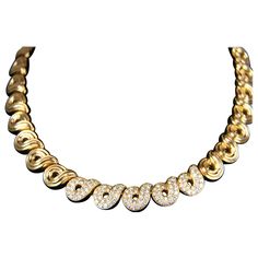 Designer necklace by Boucheron is a heavy 118.7 grams of 18K Yellow Gold and features ribbed swirl design links continuously wrapping the neck in an elegant pattern. Necklace features a hidden box clasp design secured with a fold under latch for additional safety. Approximately 16 inches long, the design is further enhanced with 3 carats of bright round brilliant cut diamond pave set on the center five links. Don't miss out on this truly stunning and timeless piece to add to your fine jewelry co Gold And Diamond Necklace, Designer Necklace, Gold Diamond Necklace, Box Clasp, Antique Diamond, Swirl Design, Fine Jewelry Collection, 3 Carat, Link Necklace