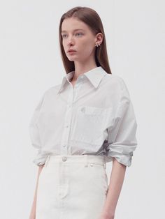 This product is an embroidered stripe pocket shirt that offers a casual yet refined look. The shirt features classic pinstripes, a pointed collar, and button cuffs, while the subtle embroidery on the chest pocket adds a touch of individuality. Made from a lightweight fabric, it's suitable for both layering and as a single piece. - The shirt's straight-cut silhouette provides a relaxed fit, comfortable for day-long wear.- Its button-down front is both functional and adds a traditional element to the design.- The rolled-up sleeves pictured give it a laid-back, versatile style.- This piece can be effortlessly incorporated into both professional and casual wardrobes due to its classic pattern and tailored look. White Button-up Top With Pockets, White Vertical Stripe Button-up Shirt, White Horizontal Stripe Button-up Top, Pinstripe Cotton Button-up Shirt, Pinstripe Long-sleeved Shirt With Button Closure, Pocket Shirt, Straight Cut, Classic Pattern, Single Piece