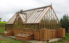 a wooden greenhouse with hot tubs in it