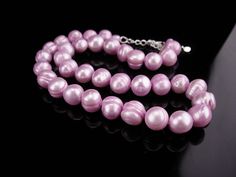 Pink Single Strand Pearl Necklace For Gift, Pink Pearl Necklace With Round Beads For Gift, Pink Pearl Necklace For Gift, Pink Round Beads Pearl Necklace For Gift, Pink Pearl Charm Necklace For Formal Occasions, Formal Pink Pearl Charm Necklace, Pink Pearl Drop Necklace For Gift, Adjustable Pearl Necklace With Round Beads For Anniversary, Elegant Purple Pearl Necklace For Wedding