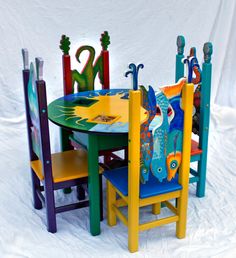 the children's table and chairs are brightly painted