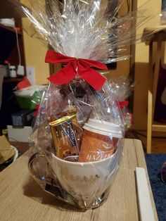 a basket filled with coffee and snacks on top of a table