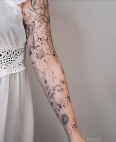 a woman's arm with flowers on it