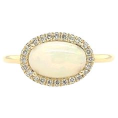 Our classic oval cabochon opal ring surrounded by 24 dazzling small diamonds, set in exquisite 14ct yellow gold setting. Total Weight: 2.4g Total Opal weight: 1.83ct Total Diamond Weight: 0.16ct Diamond Colour: H Diamond Clarity: SI1 Ring Size: M1/2 Width of Band: 1.75mm Width of Head: 9.0mm Length of Head: 12.30mm SMS8787 Oval Opal Ring, Oval Ring, Yellow Gold Setting, Oval Rings, Opal Ring, Oval Cabochon, Cluster Ring, Diamond Clarity, Opal Rings