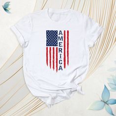 America Shirt, USA Flag Tshirt, Independence Day Tee, Red White And Blue Outfit, Patriotic American Flag Shirt, American Flag Tee, USA Shirt. These t-shirts often feature a design bearing the national symbols and colors of the United States. They are also frequently preferred during election periods. How To Order: - Please, check all tees color and  size charts. - Select your shirt size, color and quantity from the drop-down menu. - Click the "Add to cart" button. You can come back to add more i Memorial Day Cotton Crew Neck T-shirt, Casual Red T-shirt With American Flag Print, Casual Red T-shirt For 4th Of July, American Flag Print T-shirt For Independence Day, American Red T-shirt With Graphic Print, Patriotic Screen Print Tops For Memorial Day, Casual Letter Print T-shirt For Independence Day, Patriotic Red T-shirt With American Flag Print, Red Patriotic T-shirt With American Flag Print