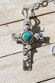 This extra large Cross necklace is just beautiful. The Cross is handmade of Sterling Silver. A Turquoise Mountain cab sits in the center and embellished with wax cast vines and roses.  The Cross is 2" x 3.75". It is on a chancy Sterling 20" chain in the pics but that can be changed easily. The bale is a shepherds hook making it easy to wear on beads, leather or a chain. Cross Necklace, Favorite Jewelry, Necklace Etsy, Jewelry Necklace Pendant, Beauty Book, Jewelry Necklaces, Turquoise, Pendant Necklace, Accessory Gift