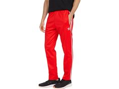 adidas Originals Beckenbauer Primeblue Track Pants - Men's Clothing : Red : You don't need to be on the track to enjoy the adidas Originals Beckenbauer Primeblue Track Pants. Settle into the comfort of these classic pants and go at your own speed. This product is made with Primeblue, a high-performance recycled material made in part with Parley Ocean Plastic. Super heavyweight fabric. Regular fit is not tight and not loose, the perfect in-between fit. Drawcord on elastic waist. Center seam detai Adidas Relaxed Fit Jogging Pants, Adidas Logo Pants With Relaxed Fit For Jogging, Casual Adidas Joggers For Workout, Casual Adidas Sweatpants For Workout, Full Length Athleisure Pants With Three Stripes, Adidas Relaxed Fit Sweatpants For Sports, Athleisure Adidas Bottoms With Athletic Fit, Relaxed Fit Sweatpants With Three Stripes For Sports, Adidas Athleisure Sweatpants For Workout